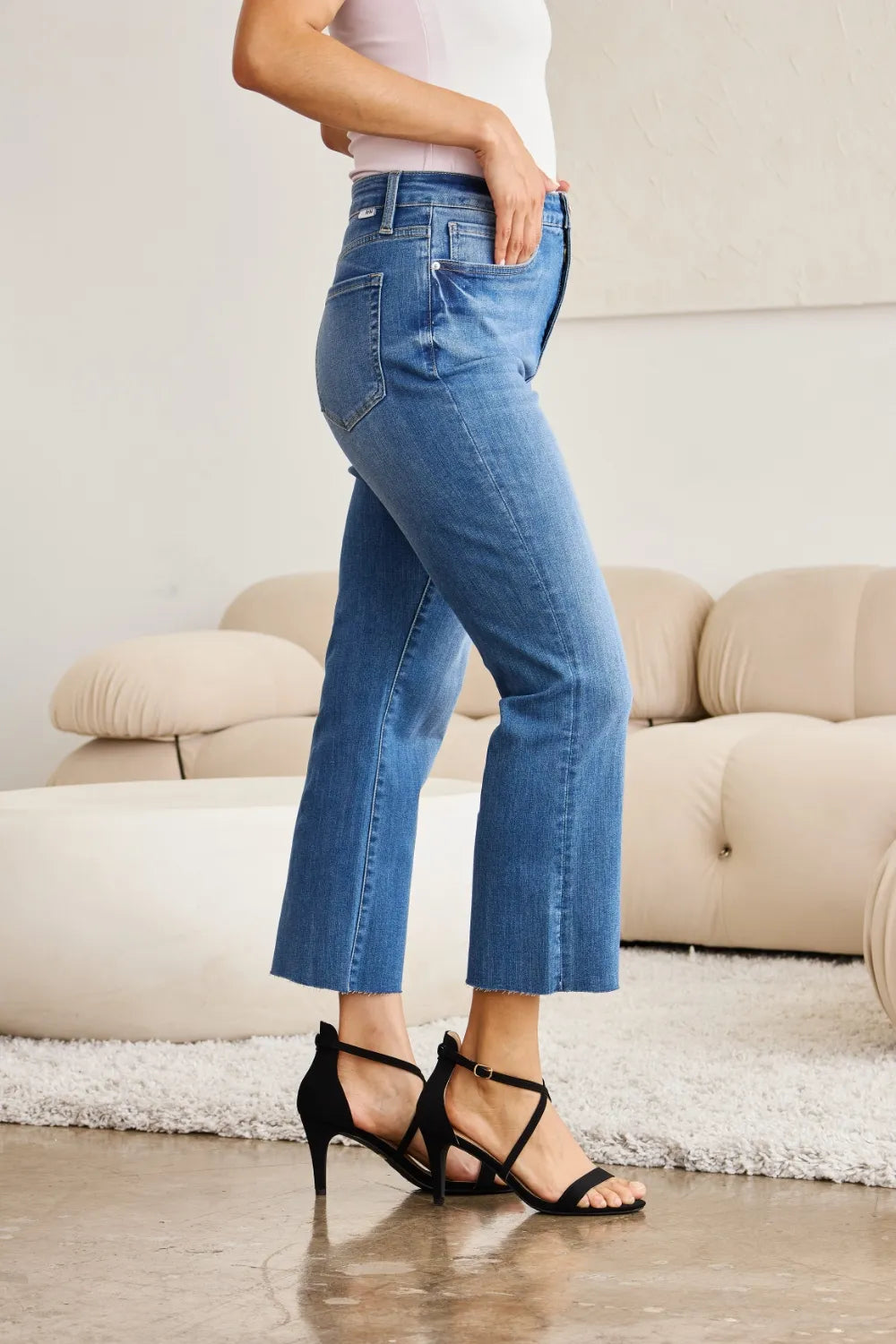 Medium wash high-waist tummy-control jeans with cropped bootcut legs