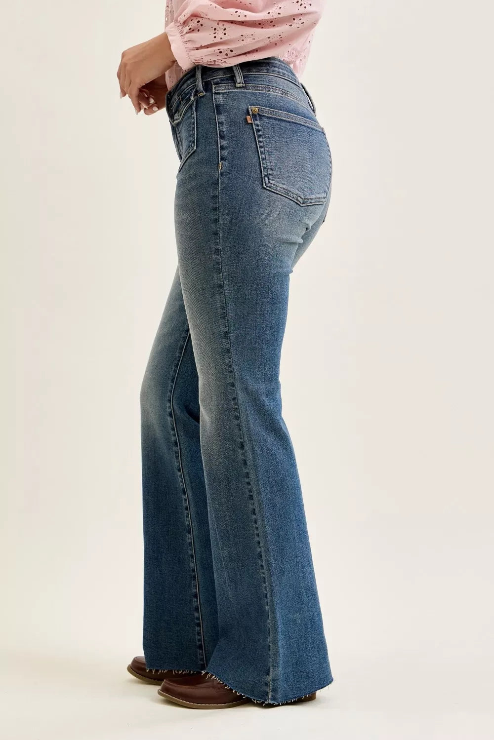 Mid-rise flare jeans, dark wash denim, back pocket and flared hem