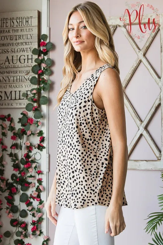 Side view of sleeveless button-front animal print top, khaki base with black spots