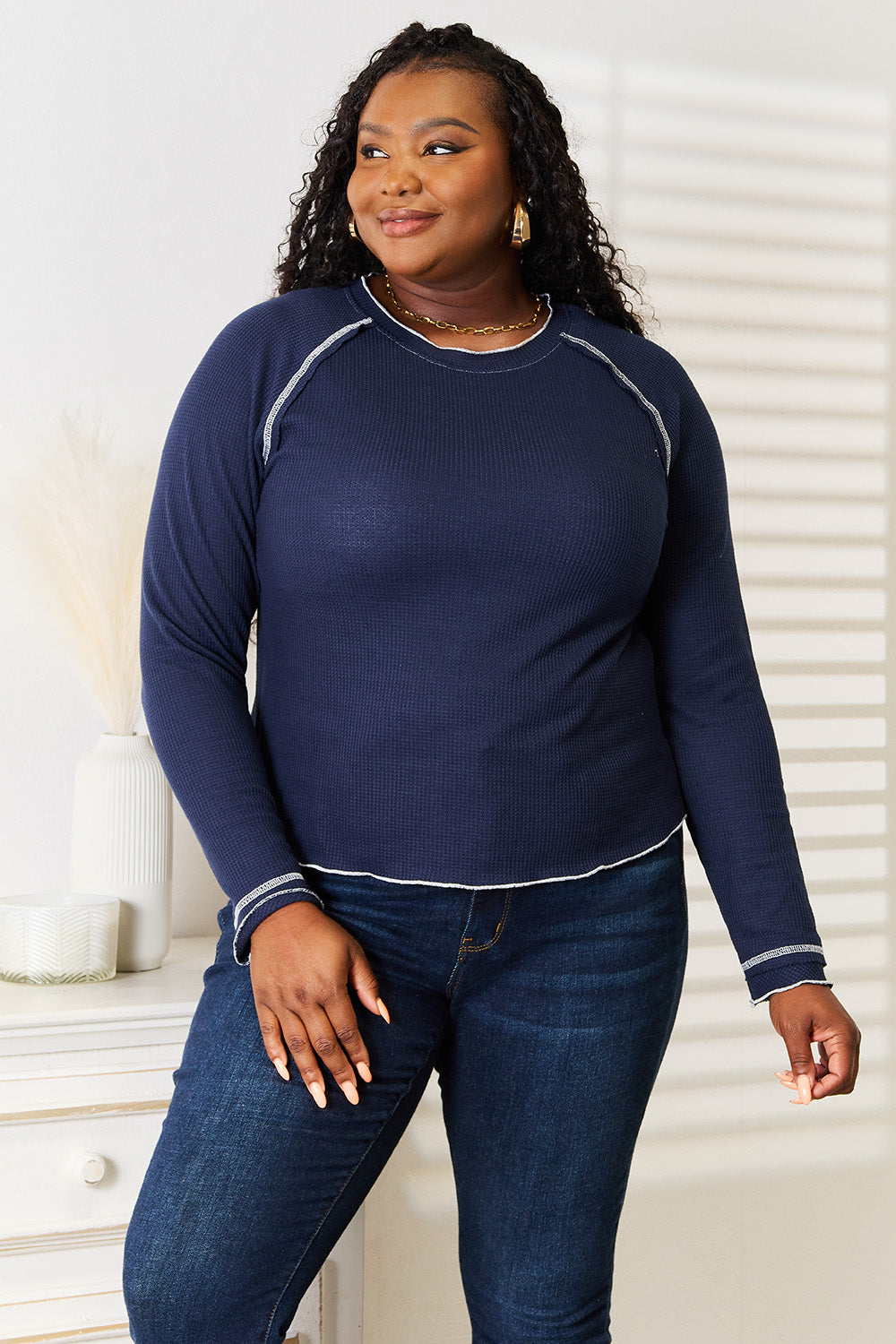 Dark blue raglan long sleeve top, round neck, white contrast trim around hem and cuffs