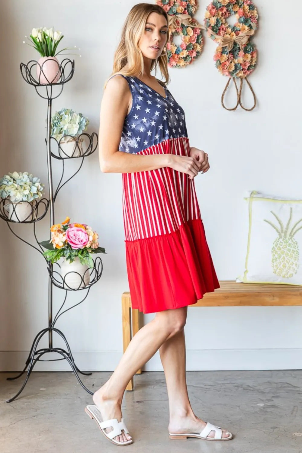Sleeveless tank dress with blue star bodice, red vertical stripes, and tiered hem