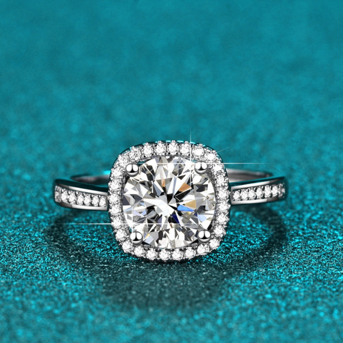 Halo moissanite ring with cushion-cut center stone and pavé side stones, silver band