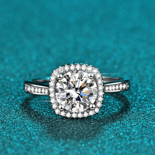 Halo moissanite ring with cushion-cut center stone and pavé side stones, silver band