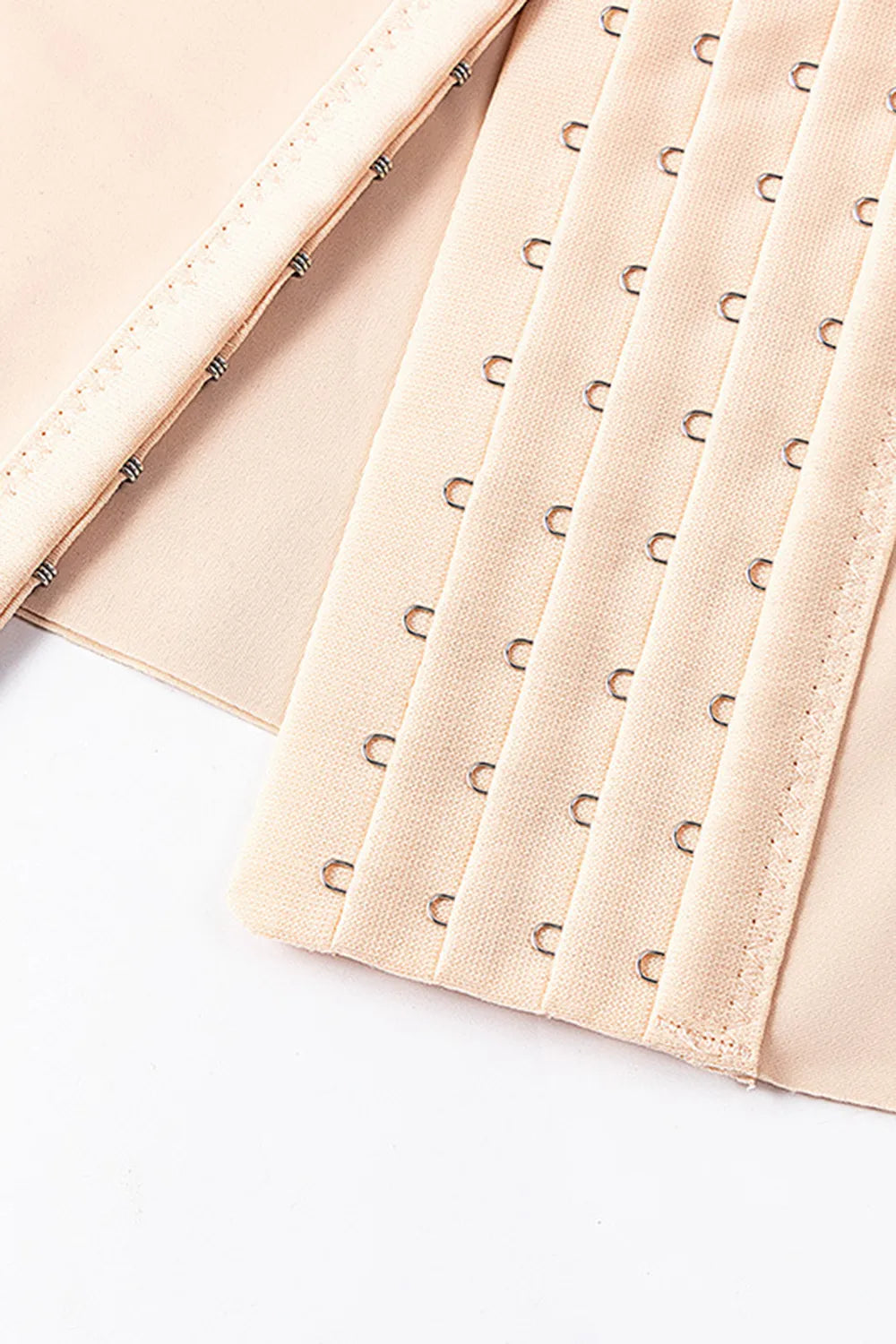 Apricot front waist cincher panel with row of hook-and-eye closures