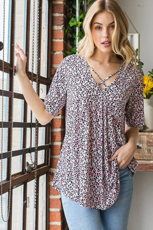 Ivory leopard-pattern babydoll top with crisscross V neckline and short sleeves