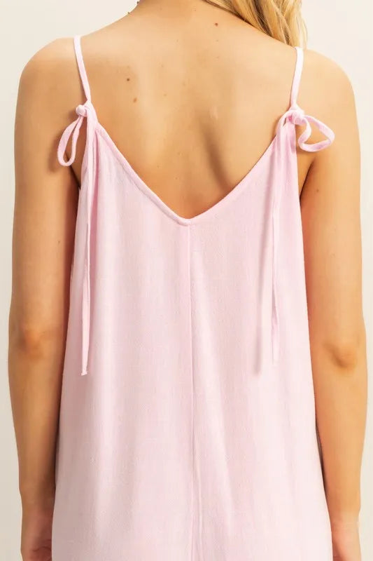 Back close-up: L.PINK V-neck romper, tied spaghetti straps and open scoop back