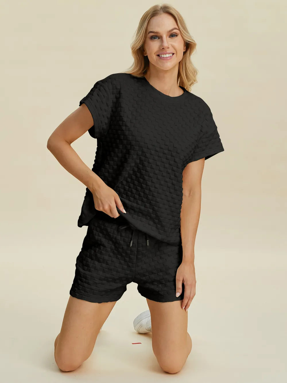 Black textured T-shirt and shorts set, crew neck top and shorts with visible drawstring.