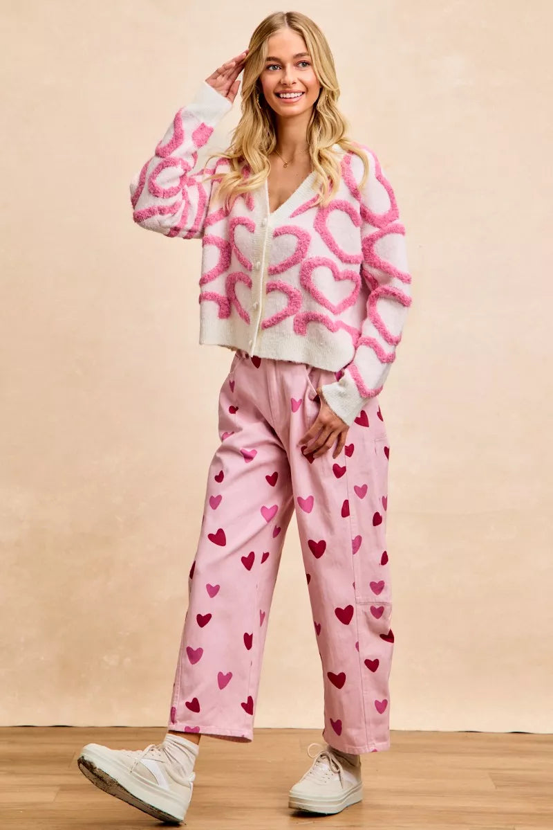 Heart-pattern cardigan in pink and white, V-neck with button closure, long sleeves