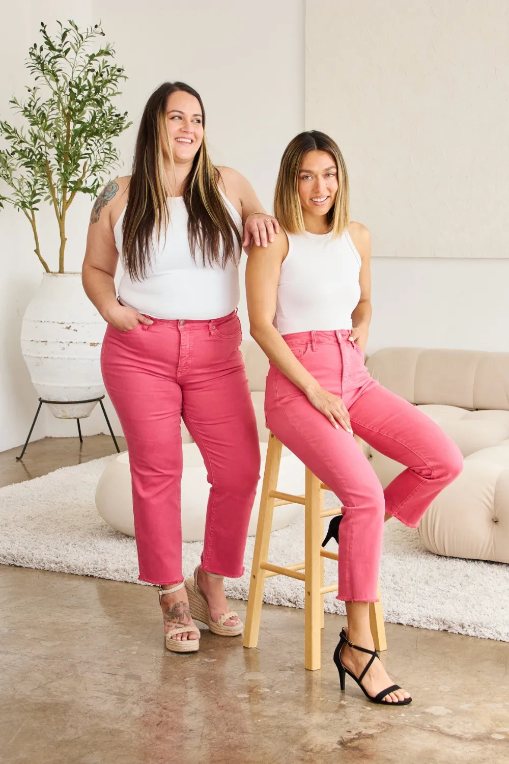Pink high-waist tummy control jeans with raw hem and cuffed ankle finish