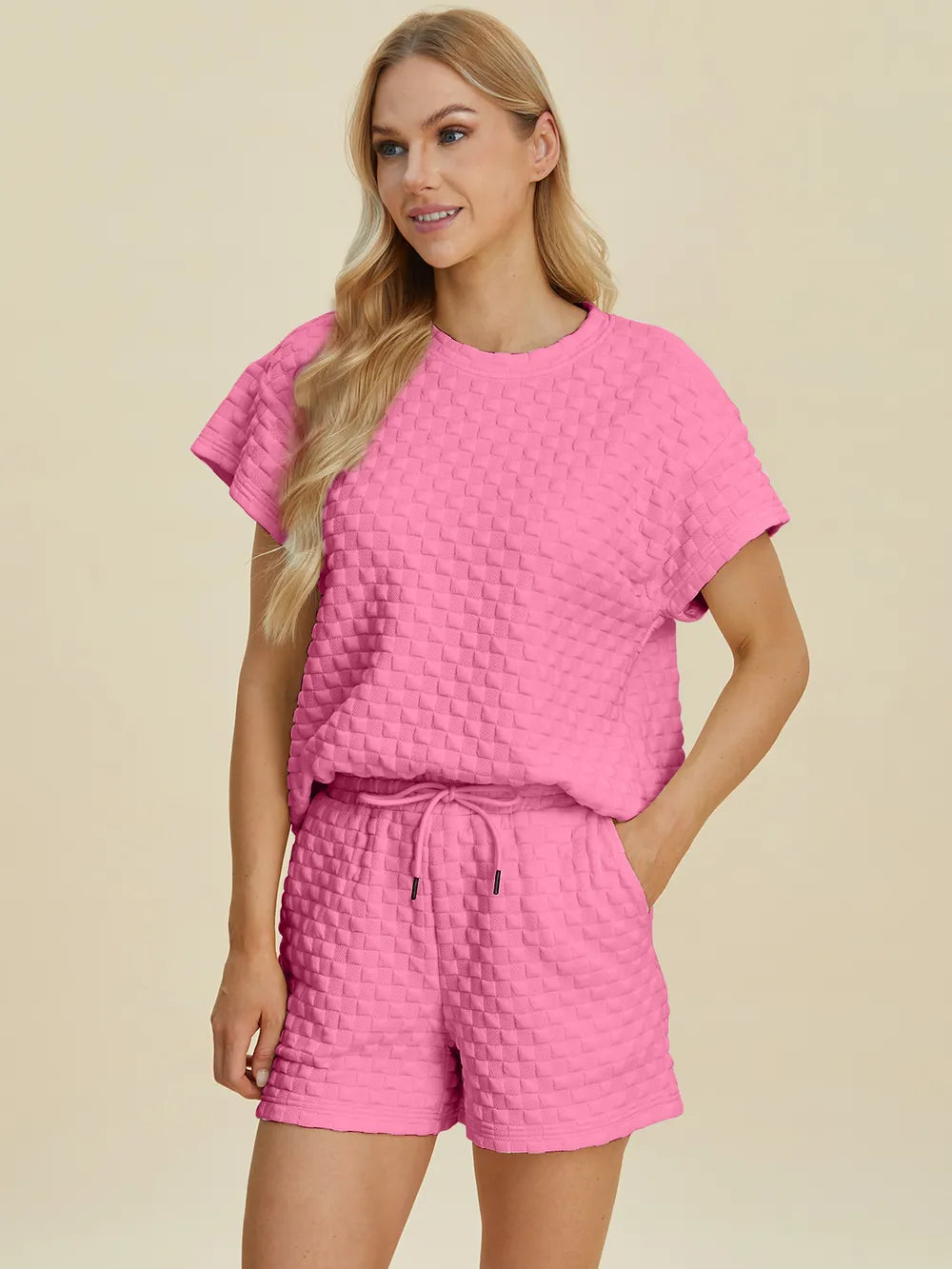 Pink textured crew neck T-shirt with matching drawstring waist shorts, front view