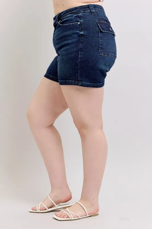 High-waist dark denim shorts, side view with back pocket