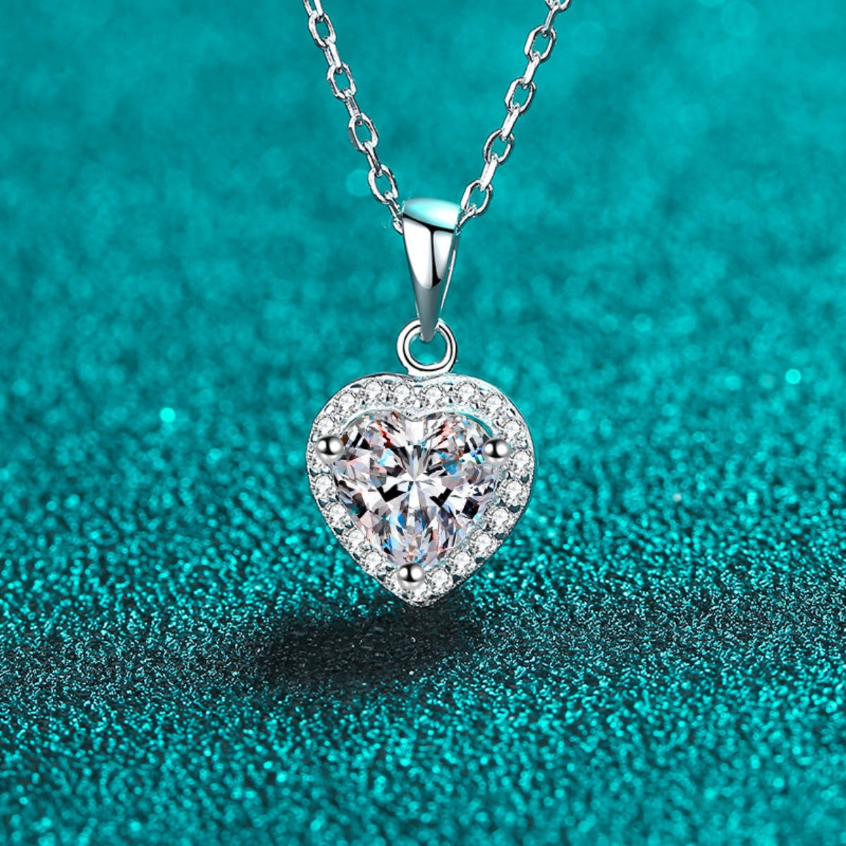 Heart pendant with sparkling border stones and clear center on silver chain