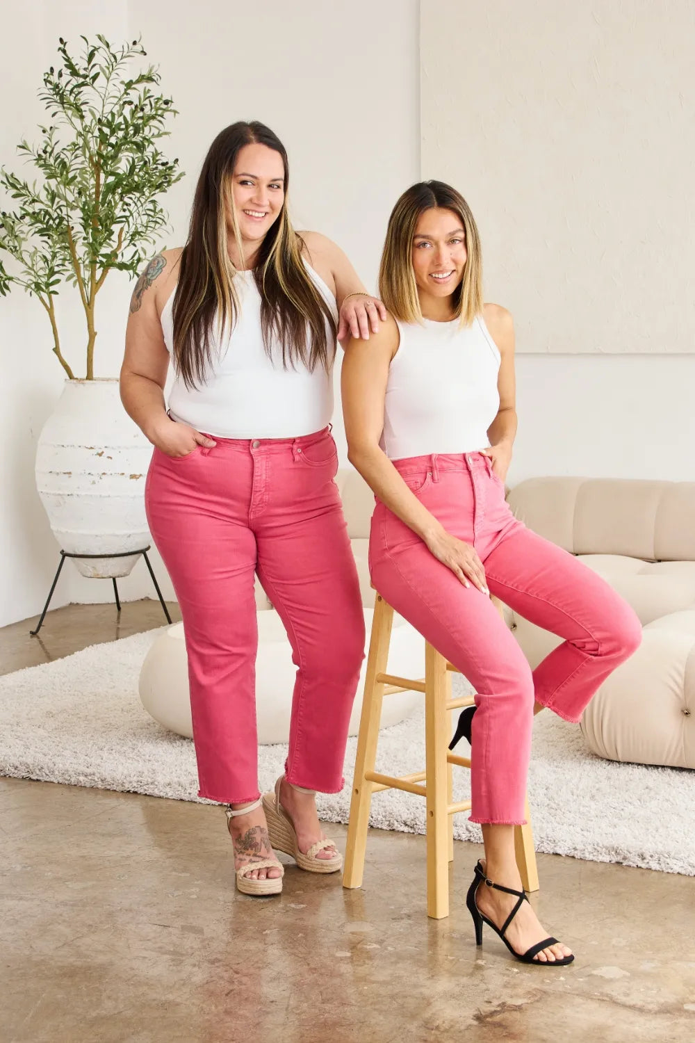 High-waist pink denim jeans with raw hem, five-pocket styling and belt loops