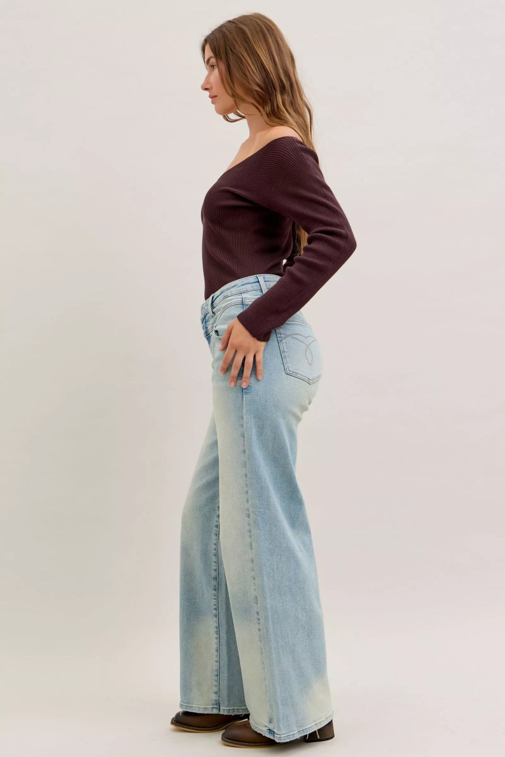 Light blue high-waist straight jeans, back/side view with back pocket seams and wide leg opening