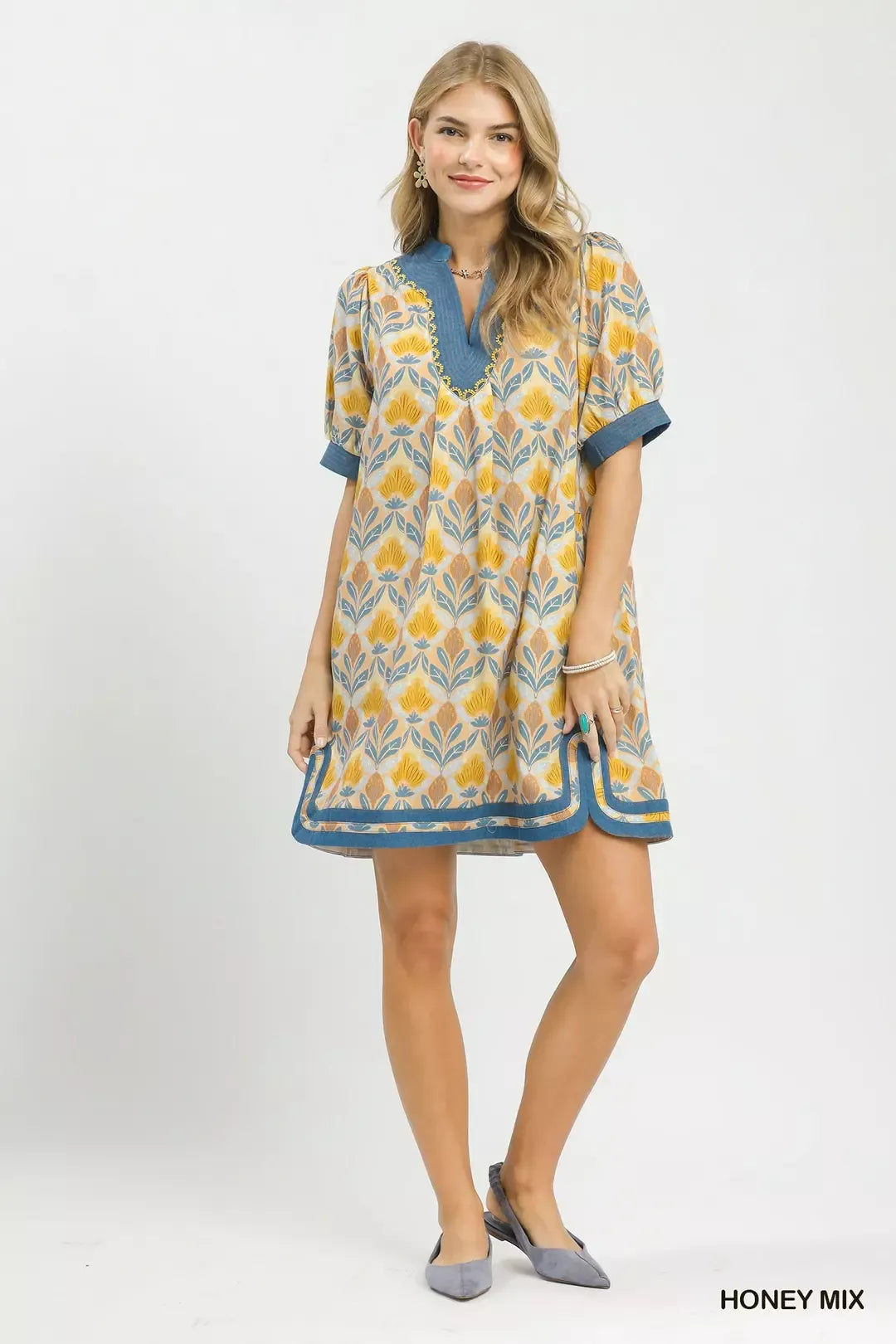 Mix tile print mini dress front view, yellow floral motifs with blue trim