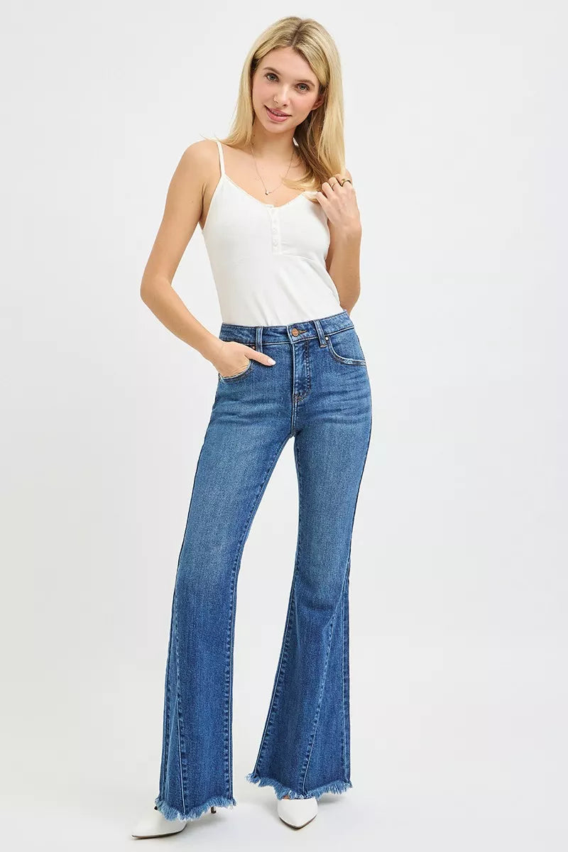 Mid-rise flare jeans in dark blue on model, frayed hem and side-seam detailing