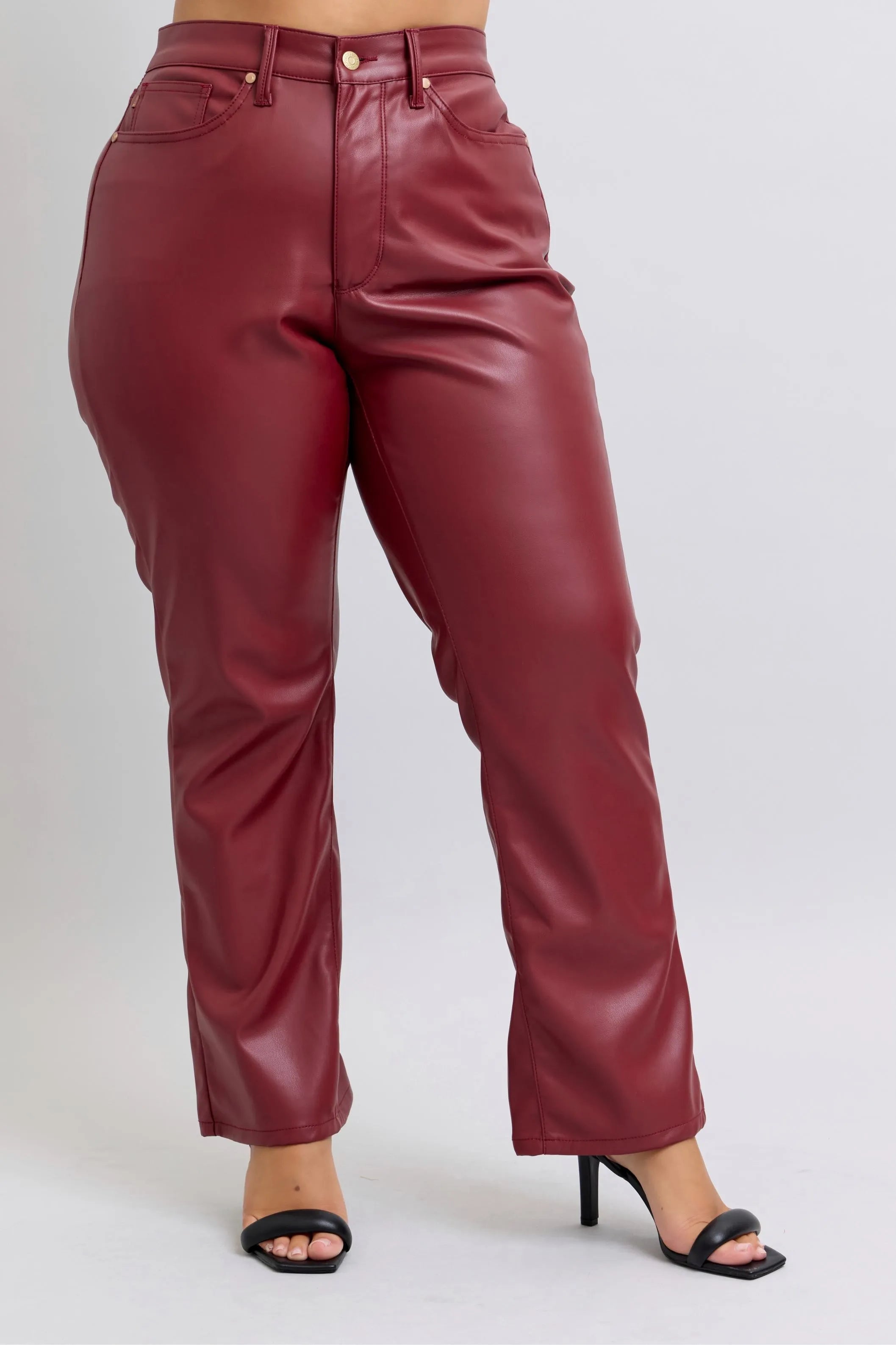 Red high-waist faux leather straight pants with front closure and belt loops