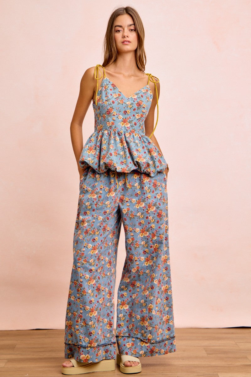 Denim-blue floral printed wide pants, full front view; drawstring tied elastic waist