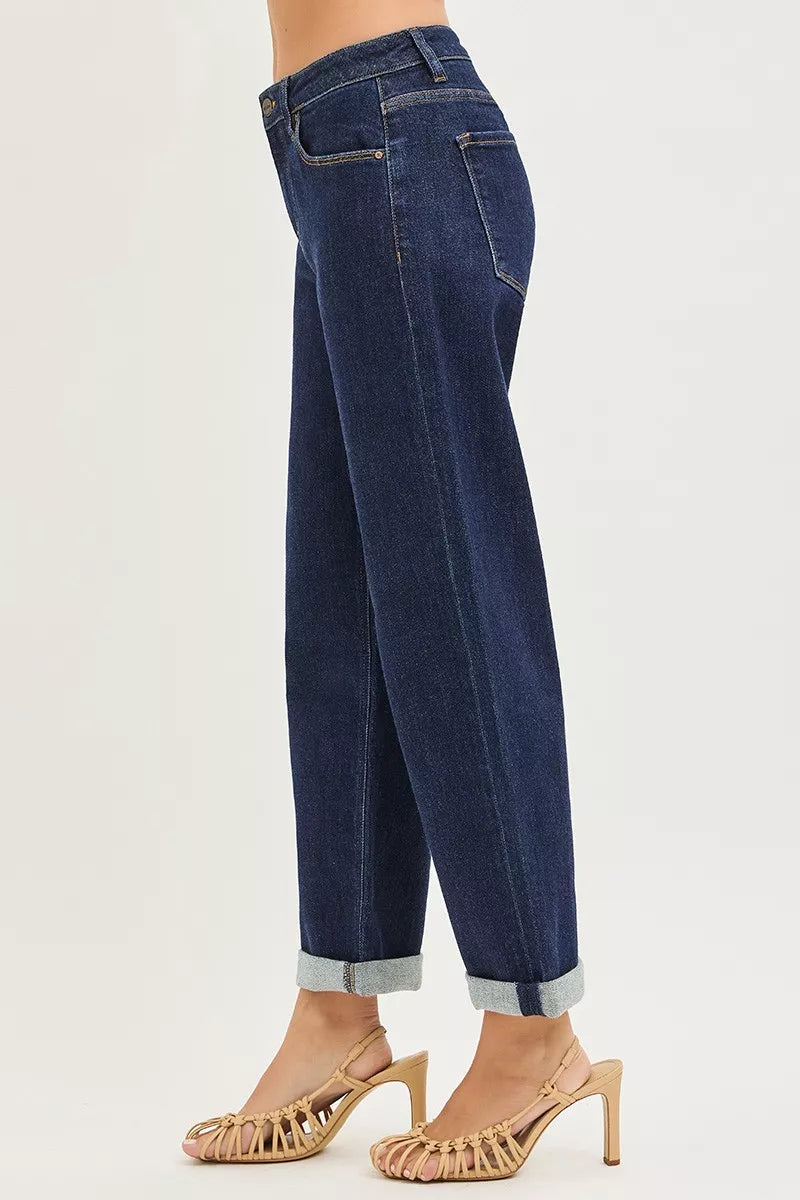 Dark blue boyfriend jeans, cuffed hem and belt loops, side profile