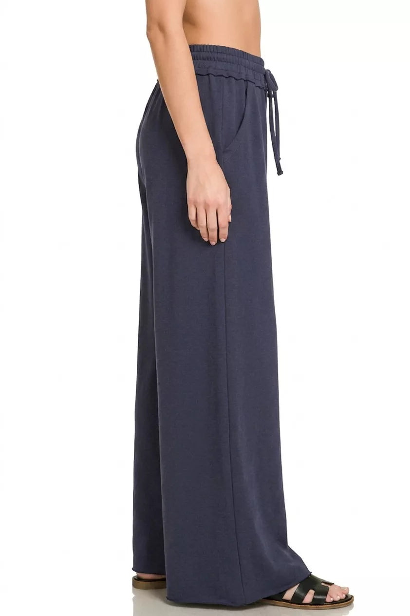 Navy wide-leg sweatpants with elastic waistband and tie drawcords, relaxed fit