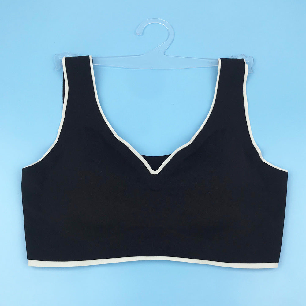 Black seamless back bra with V-neckline and wide straps, flat lay on hanger