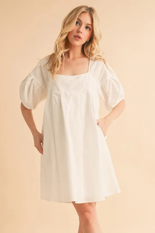 White square-neck babydoll dress with puff sleeves and gathered waist