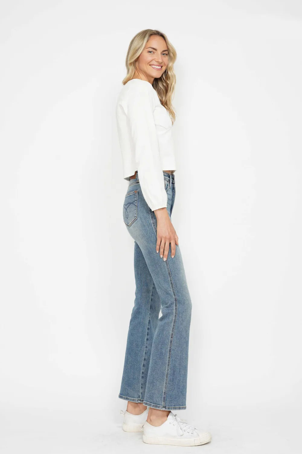 Light blue bootcut jeans, side view; flared leg with front pocket detailing