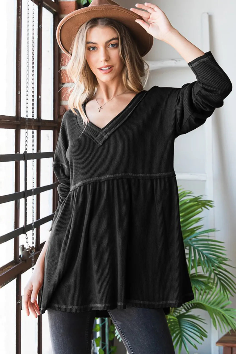 Black V-neck ribbed babydoll top with long sleeves, gathered waist; front view