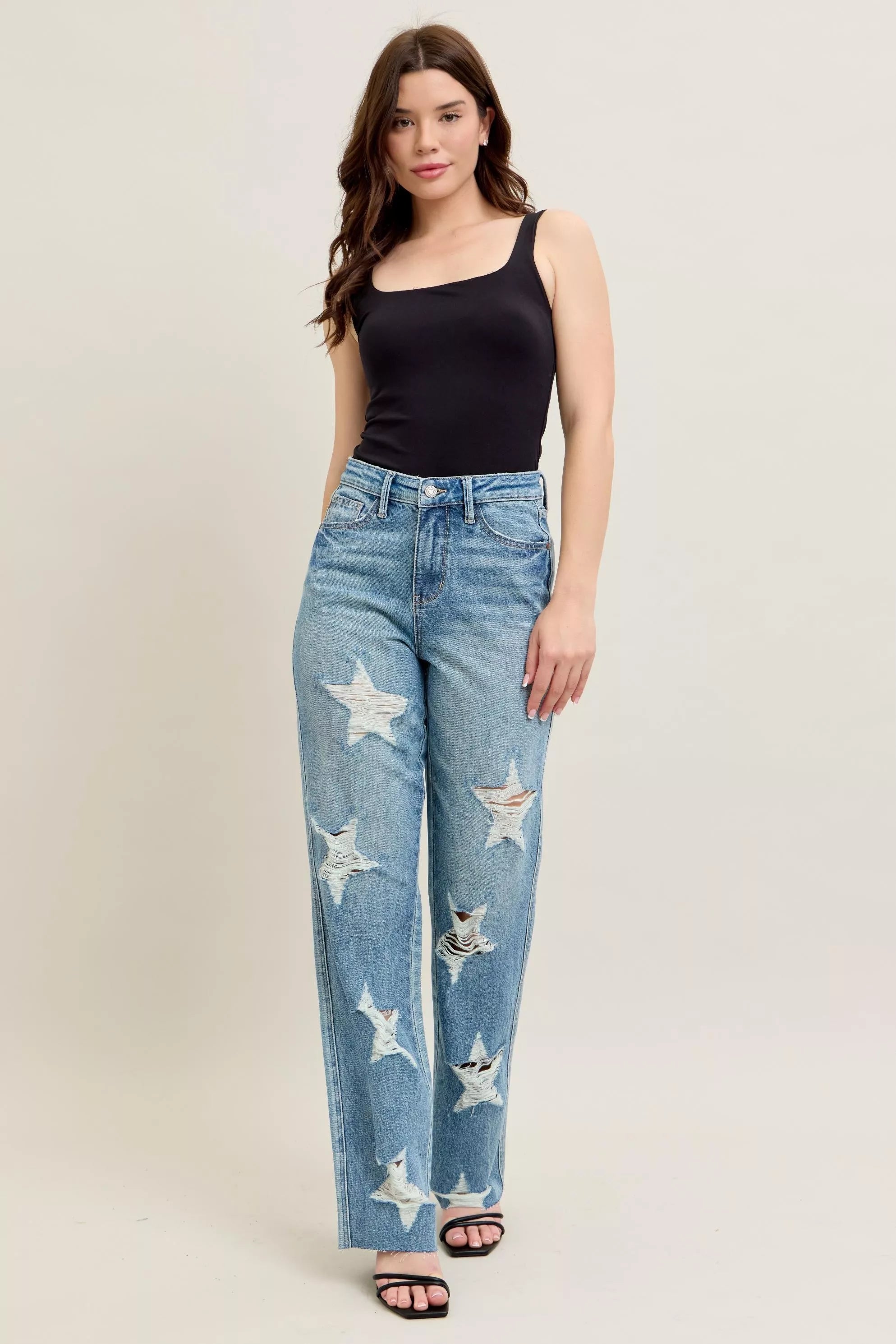 High-waist light-wash straight jeans with large star destroy patches