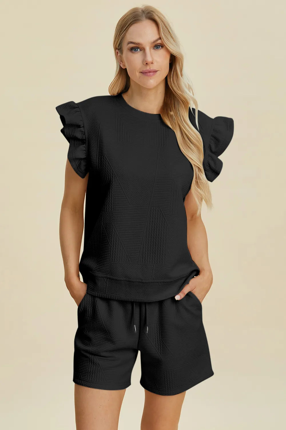 Black textured ruffle sleeve top with round neck, paired with matching drawstring shorts