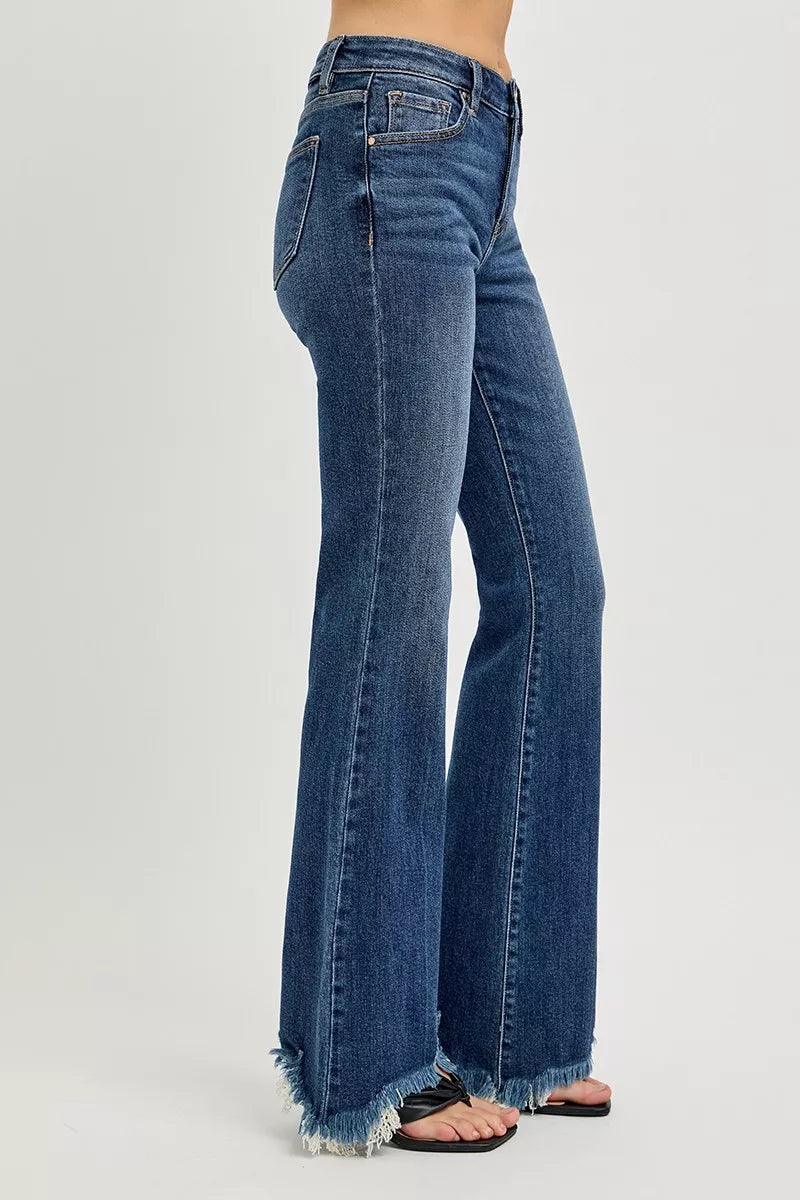 Dark blue mid-rise flare jeans side view with frayed hem detailing