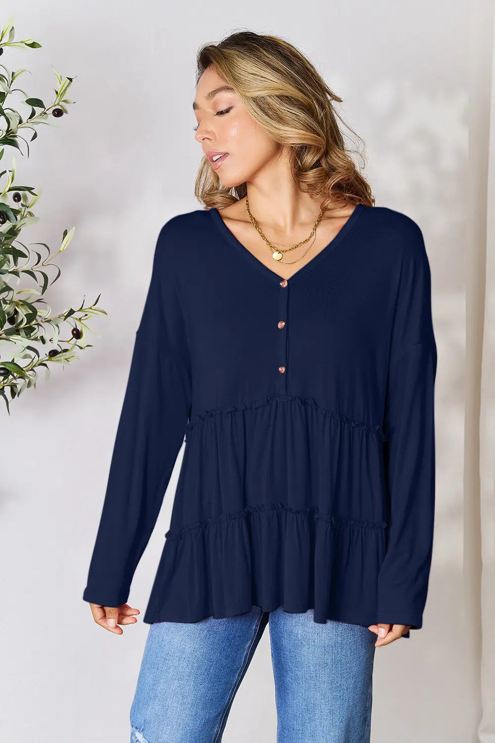 Navy tiered ruffle blouse with V-neck and half-button front, long sleeves