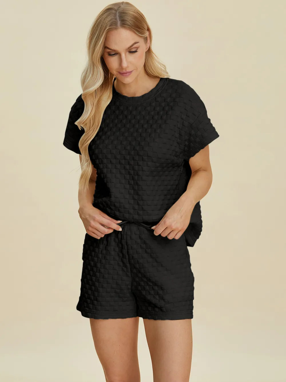 Black textured T-shirt and shorts set, relaxed fit with crew neck and straight hem shorts.