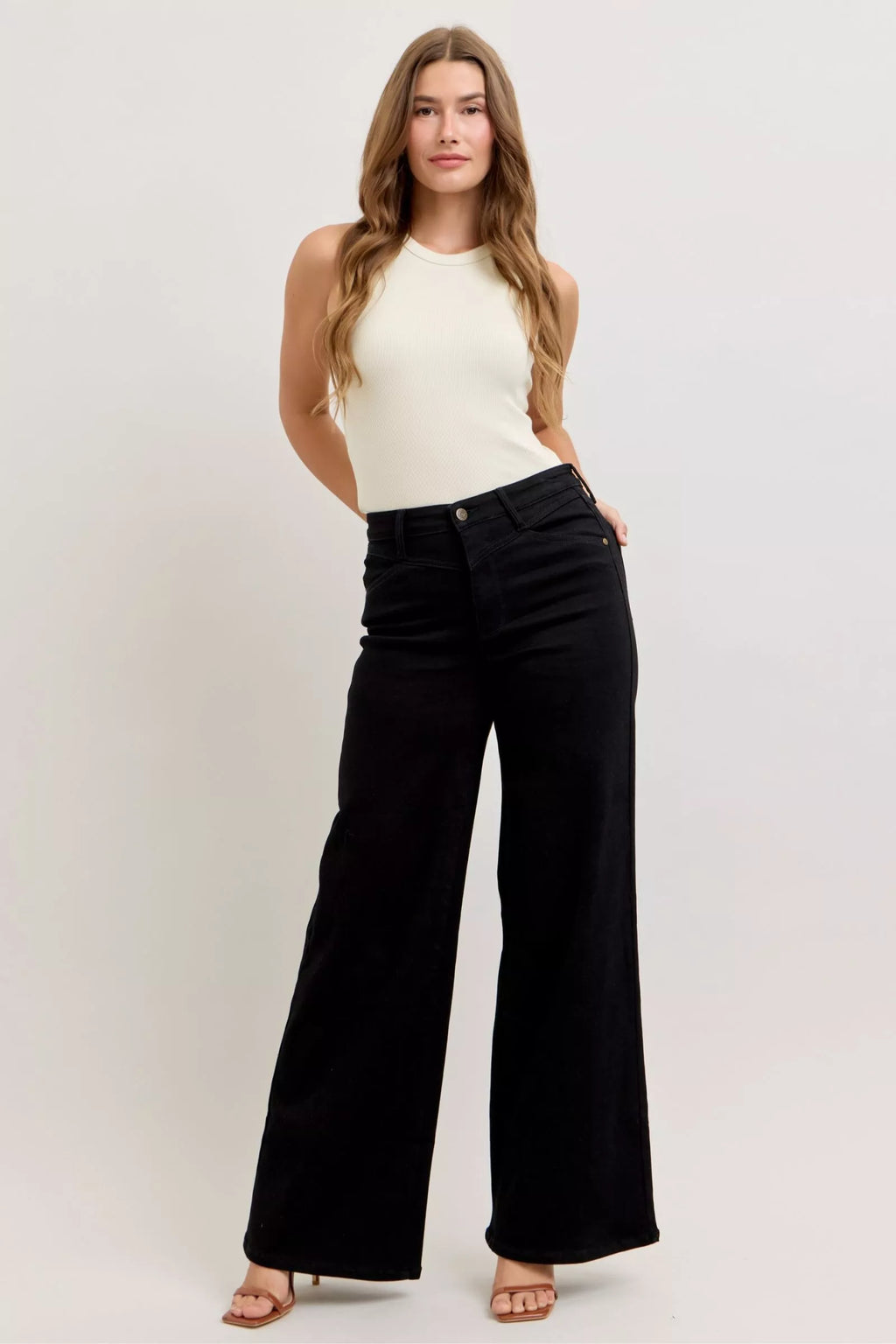 High-waisted wide-leg black jeans with straight wide leg and button fly