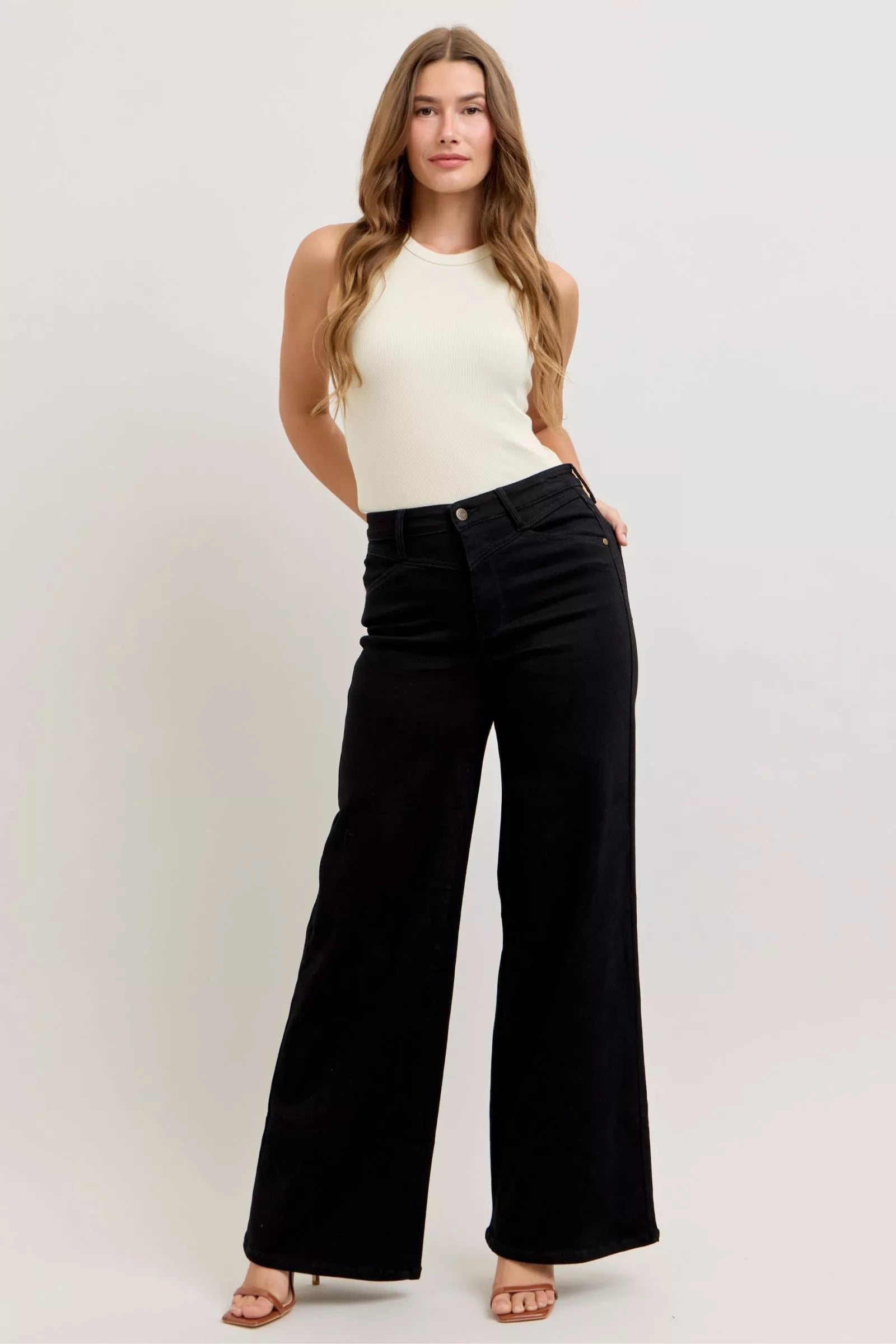High-waisted wide-leg black jeans with straight wide leg and button fly