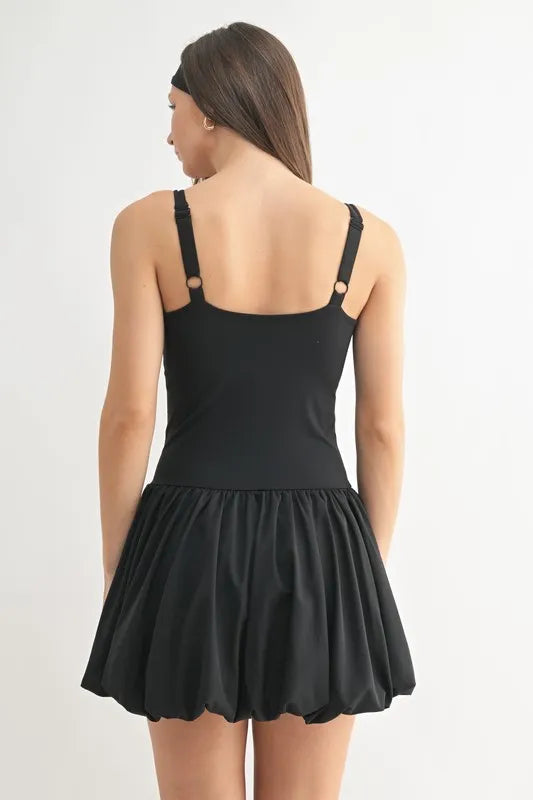 Back view of black mini dress with open scoop back and ruched bubble skirt
