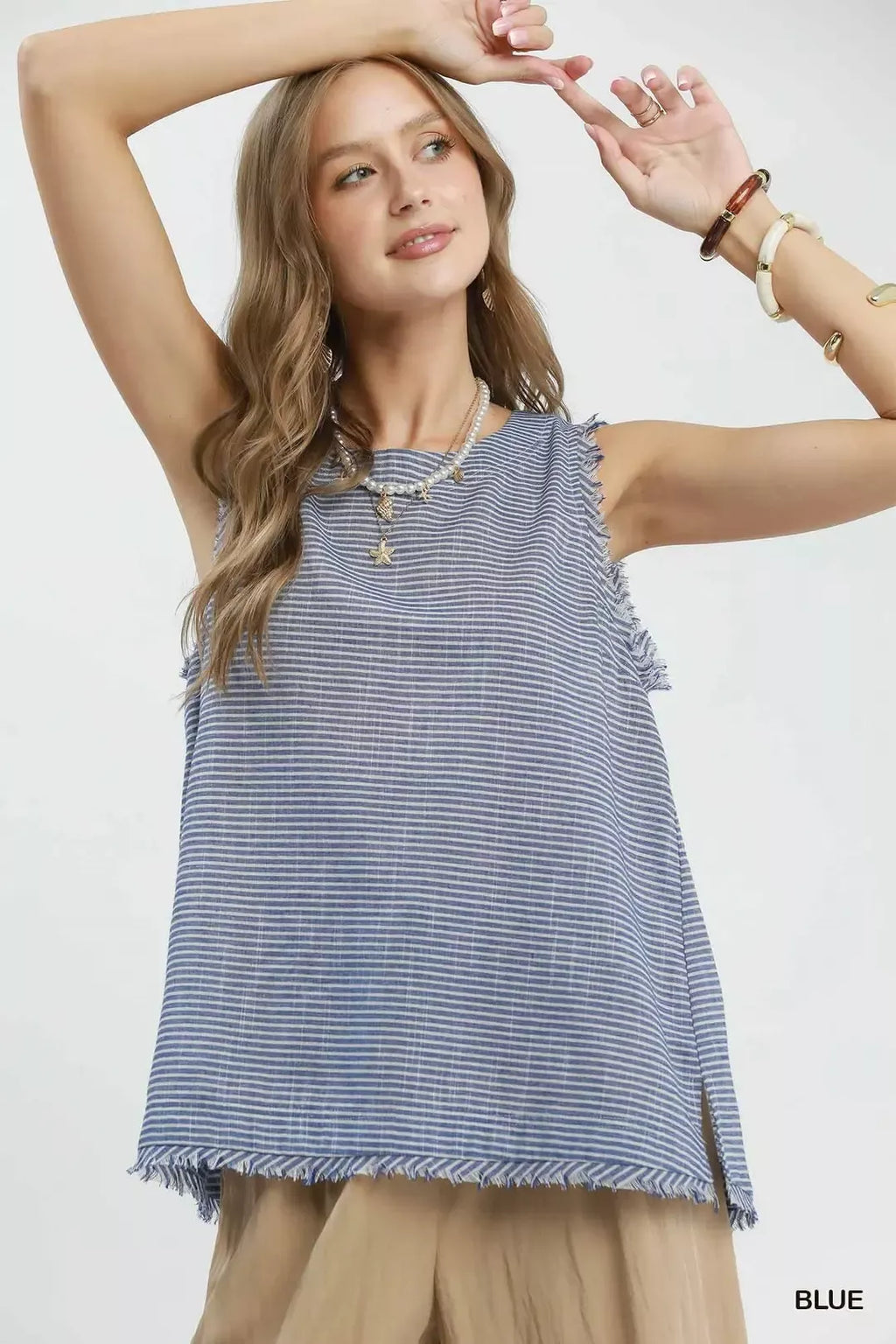 Blue striped sleeveless top with tassel fringe trim along the bottom hem
