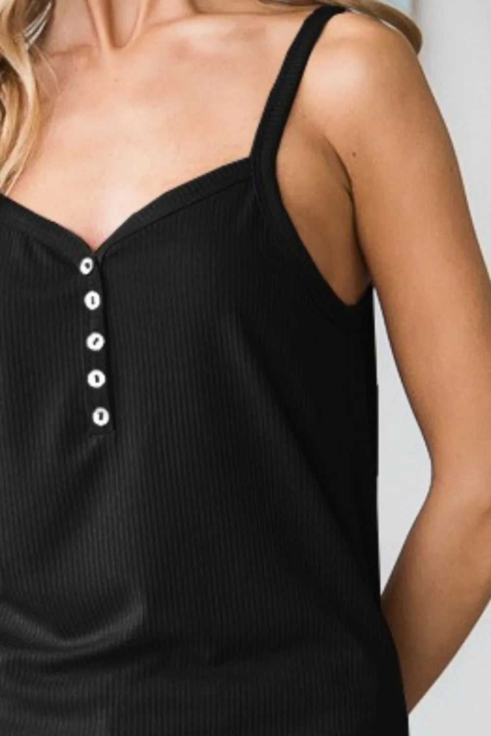 Black ribbed cami close-up: quarter buttons on front placket and V neckline