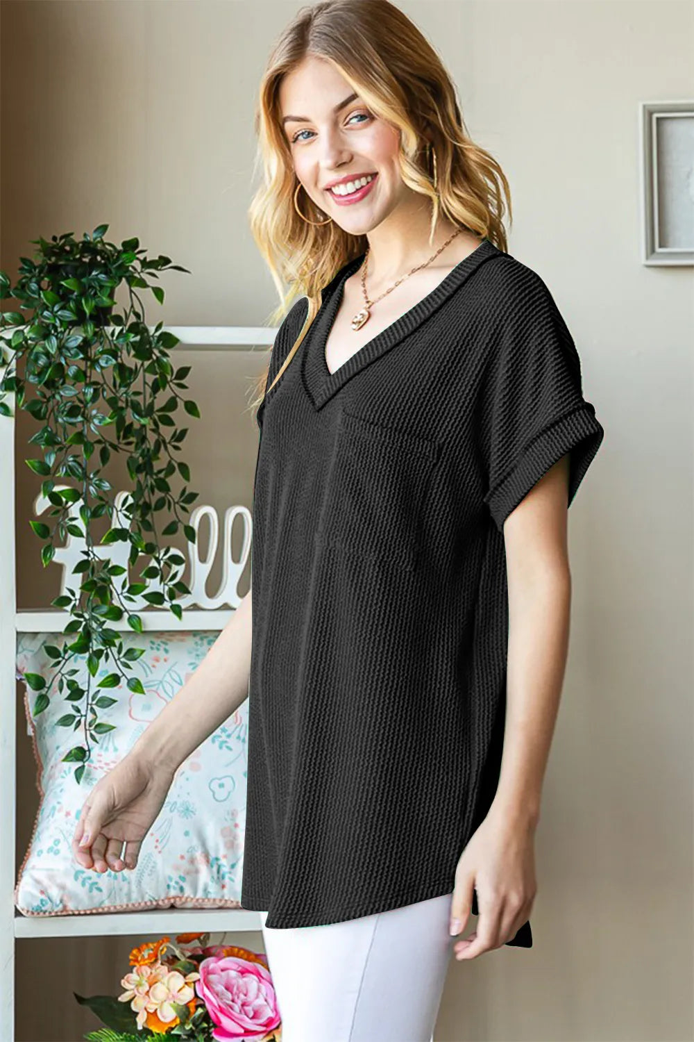 Black ribbed short-sleeve top with V-neck and front pocket