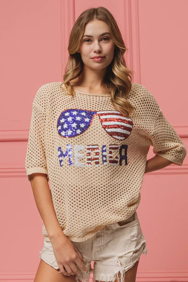 Crewneck oatmeal knit top with sequined American flag sunglasses graphic, relaxed fit