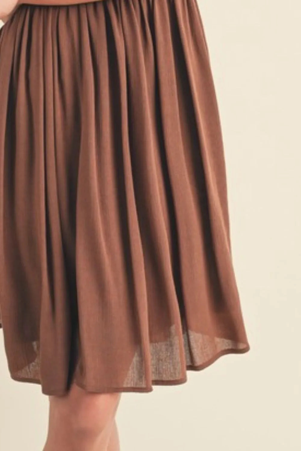 Brown ruched cami mini dress skirt with vertical gathers and sheer hem trim