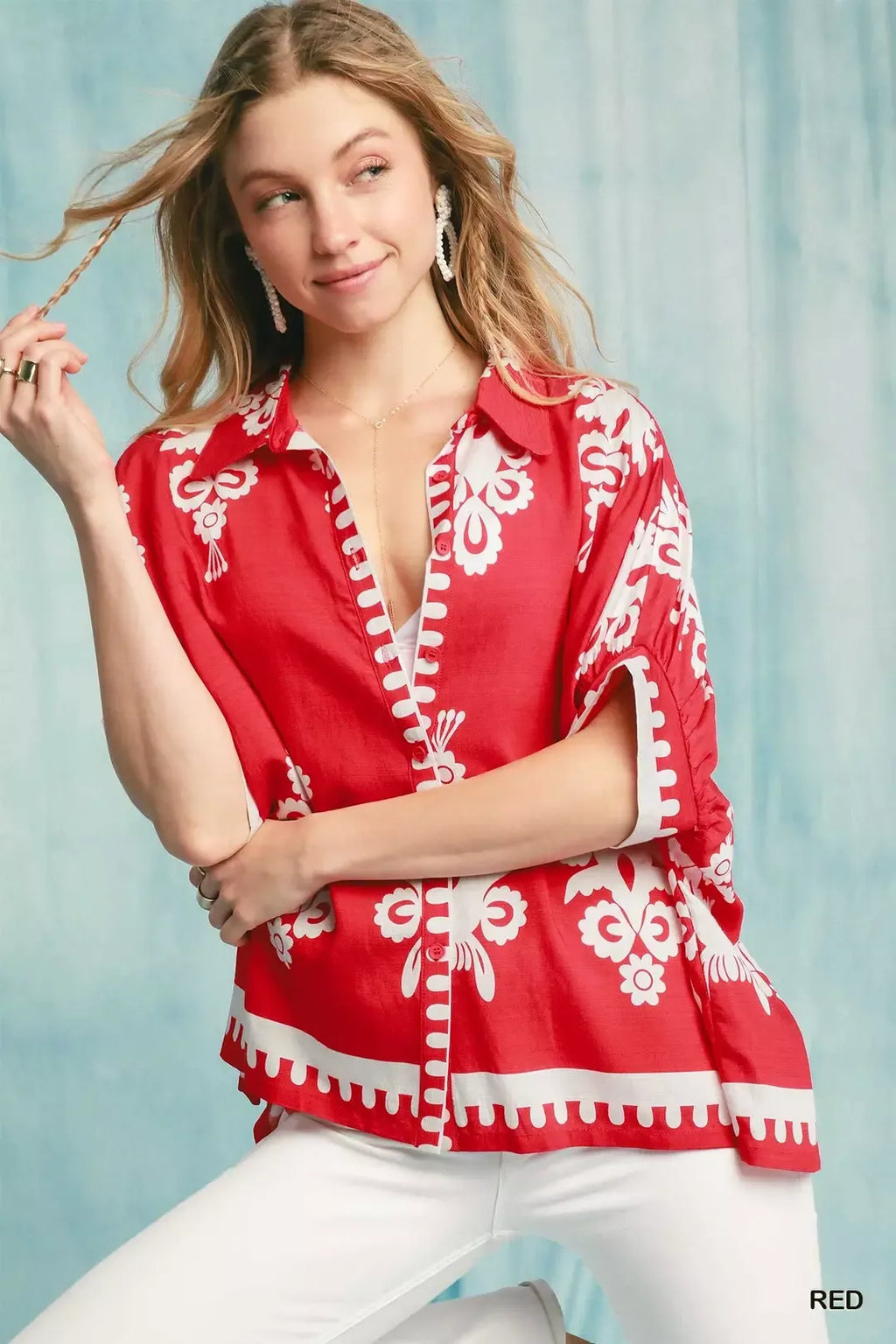 Cherry red short-sleeve button-down shirt with white floral print and V placket