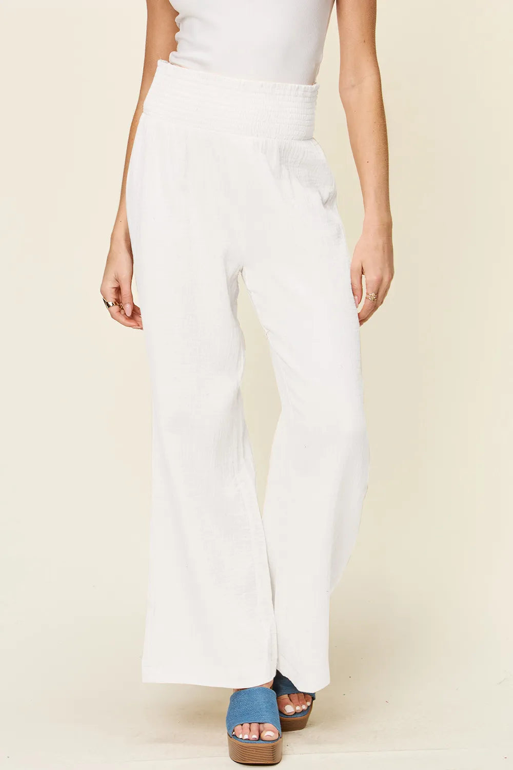 White textured wide-leg pants, smocked waistband and relaxed fit