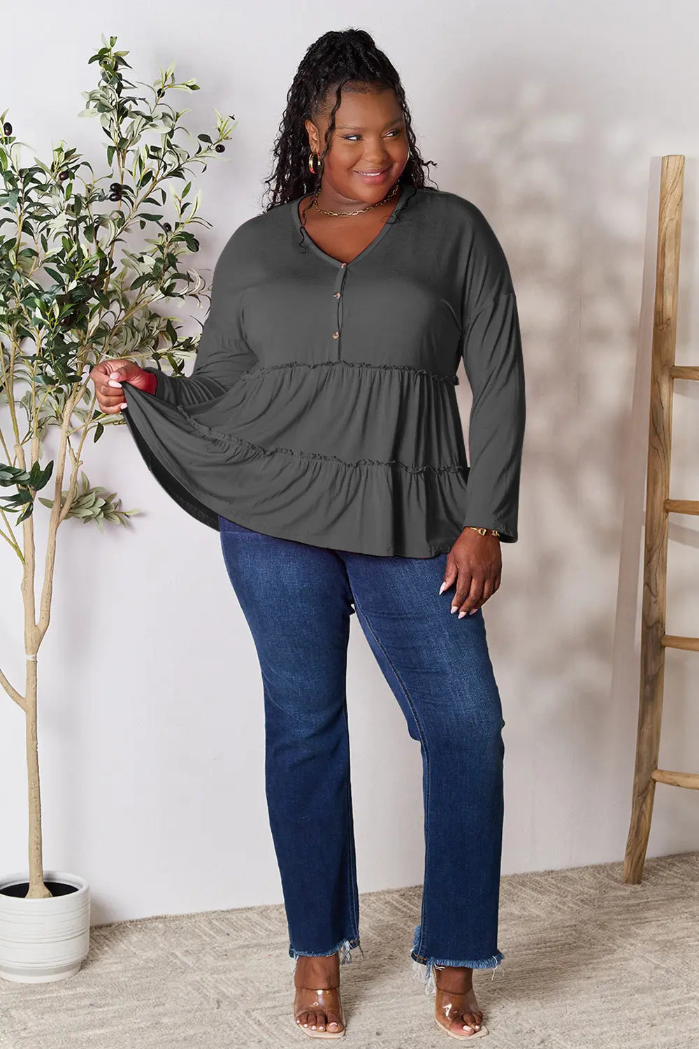 Dark gray long sleeve blouse with V-neck, half-button front, ruffle tier hem