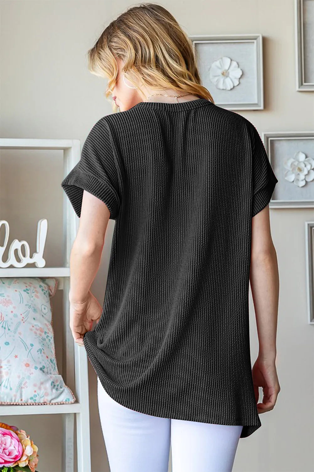 Black ribbed short-sleeve top, back view with curved hem
