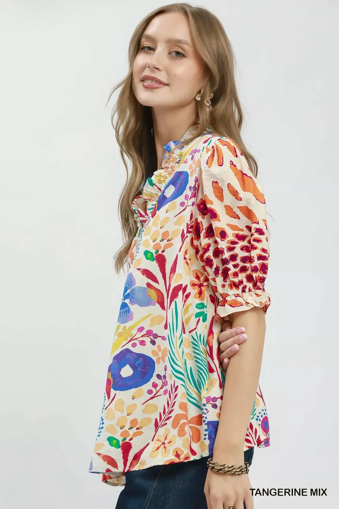 Side view of V-neck ruffle puff sleeve top with multicolor floral and animal print