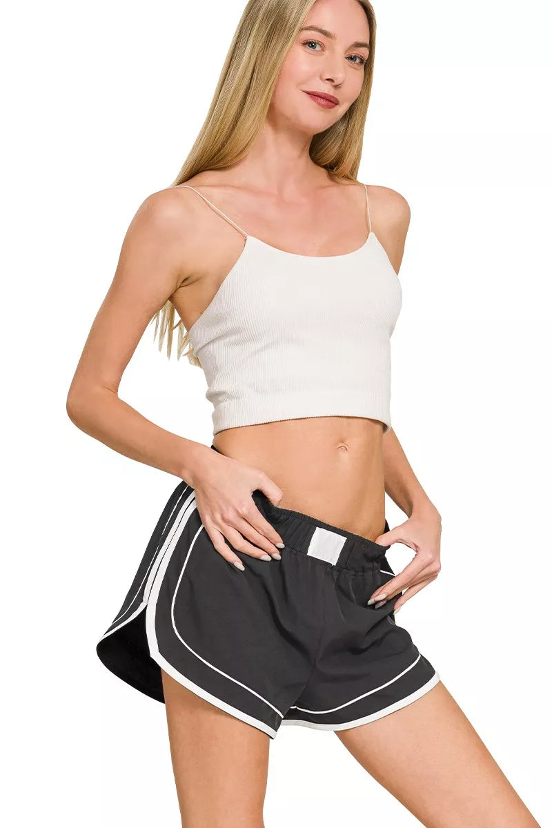 Black lined dolphin shorts with elastic waist and white contrast trim detail