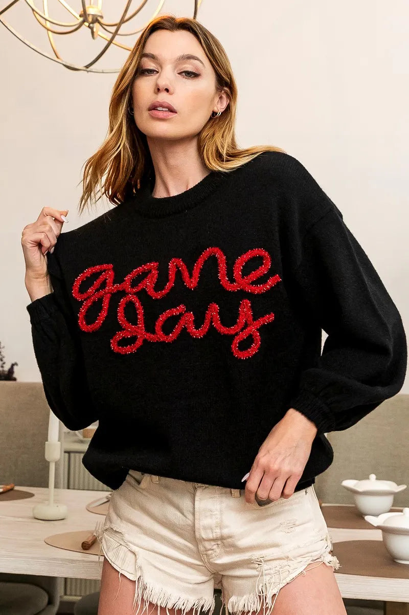 Black Game Day sweater with red script logo on chest, relaxed long sleeves