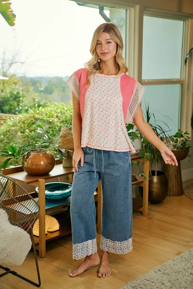 Washed denim wide-leg pants with flower lace trim along cuffs and hems.