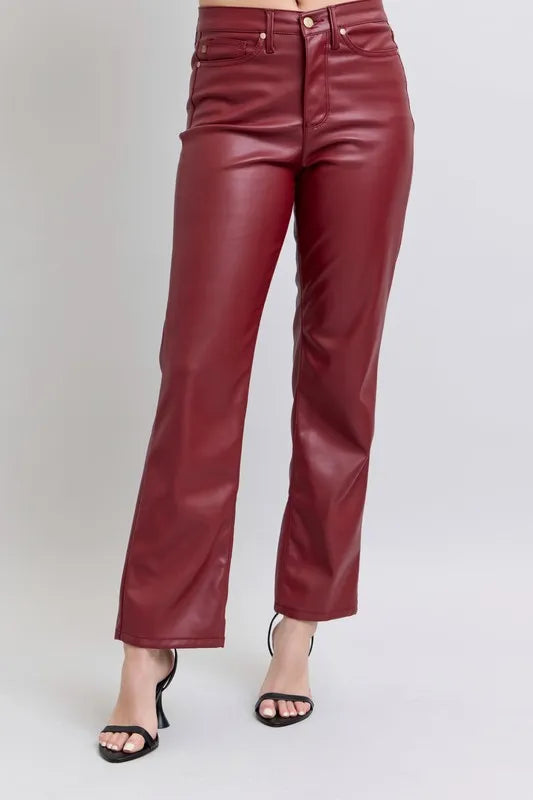 Red high-waist faux leather straight pants with front button closure and pockets